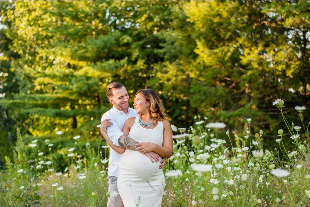 Couple outdoor Maternity Photos in field of flowers