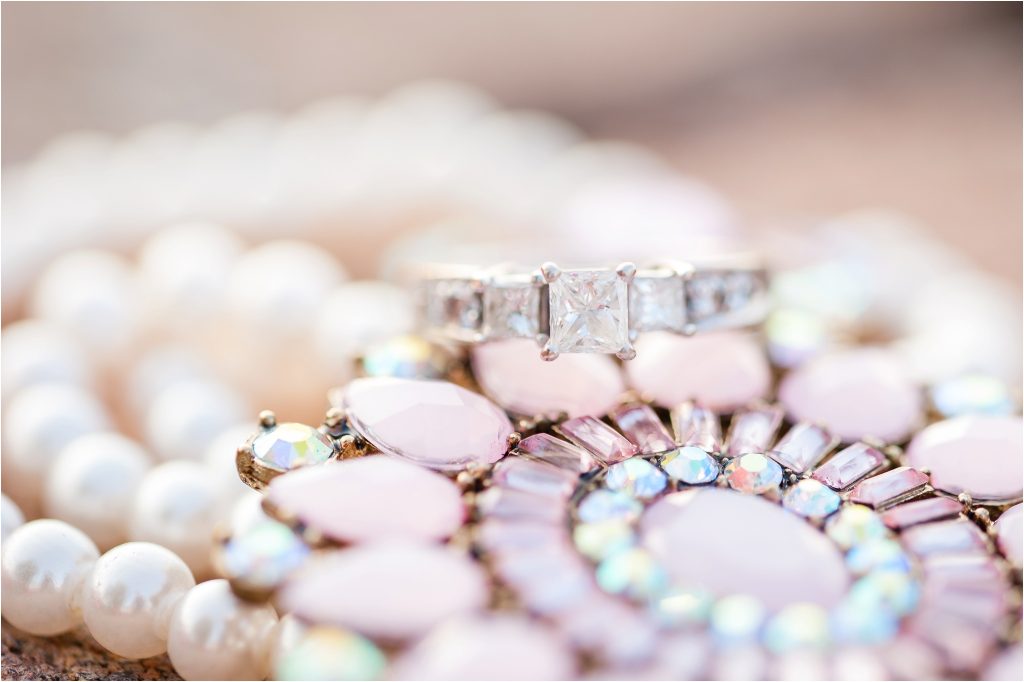 engagement ring photo with pink pearl necklace