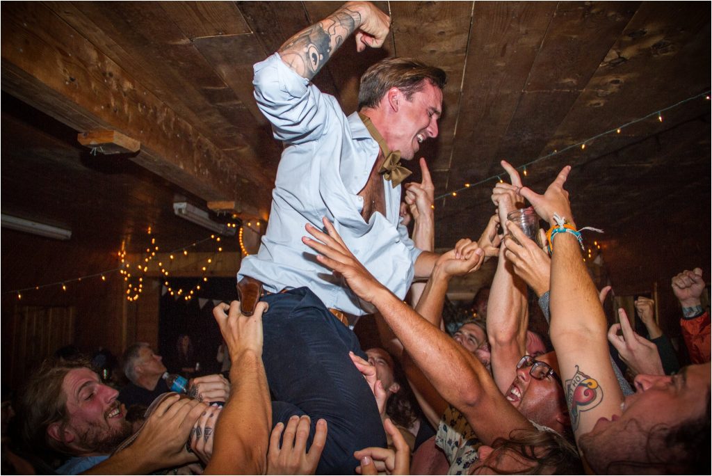 Bay of Fundy Nova Scotia Wedding, epic photo of groom crowd surfing during reception